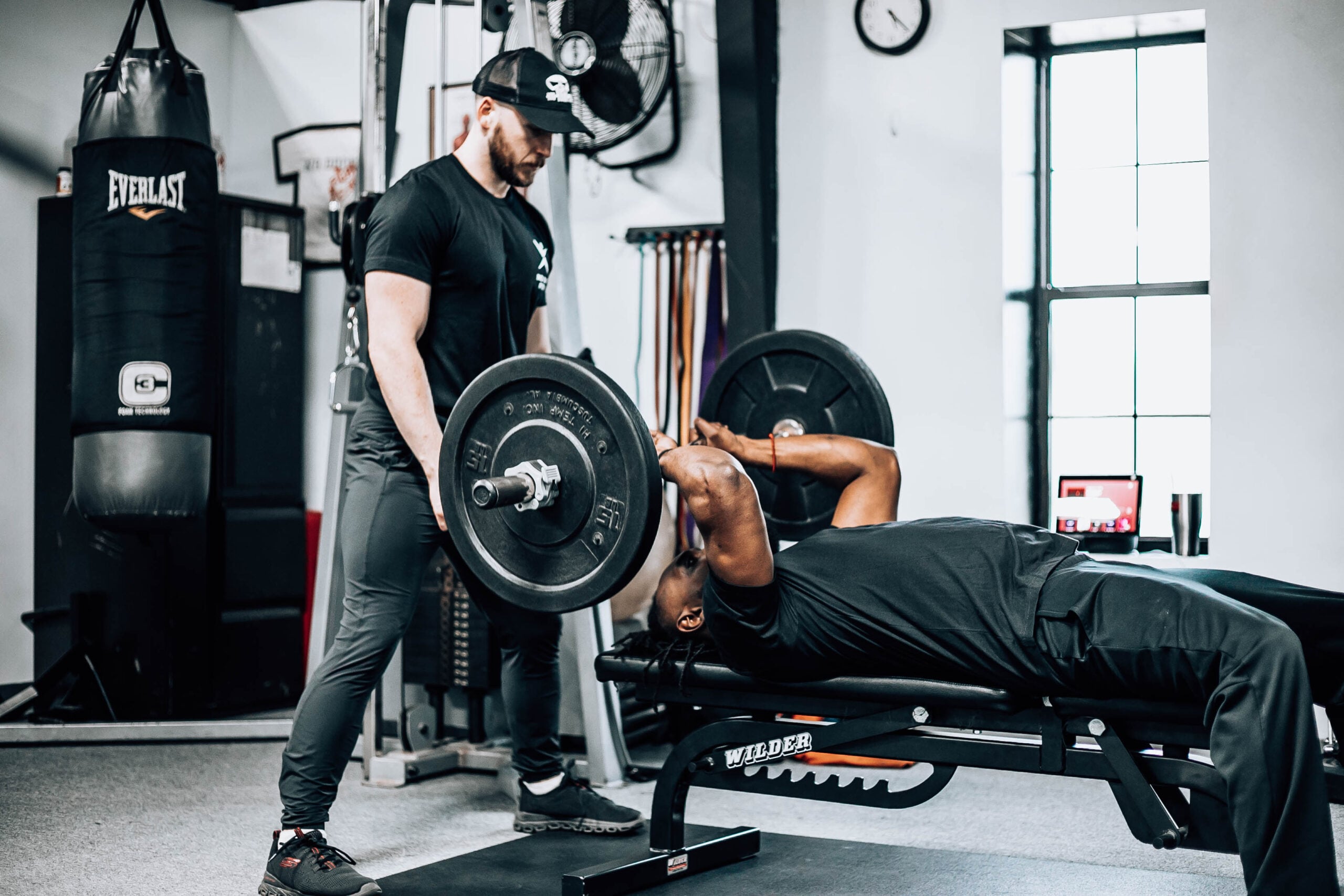 Coach guiding a client through a one-on-one personal training session at No Doubt Fitness in Muscle Shoals